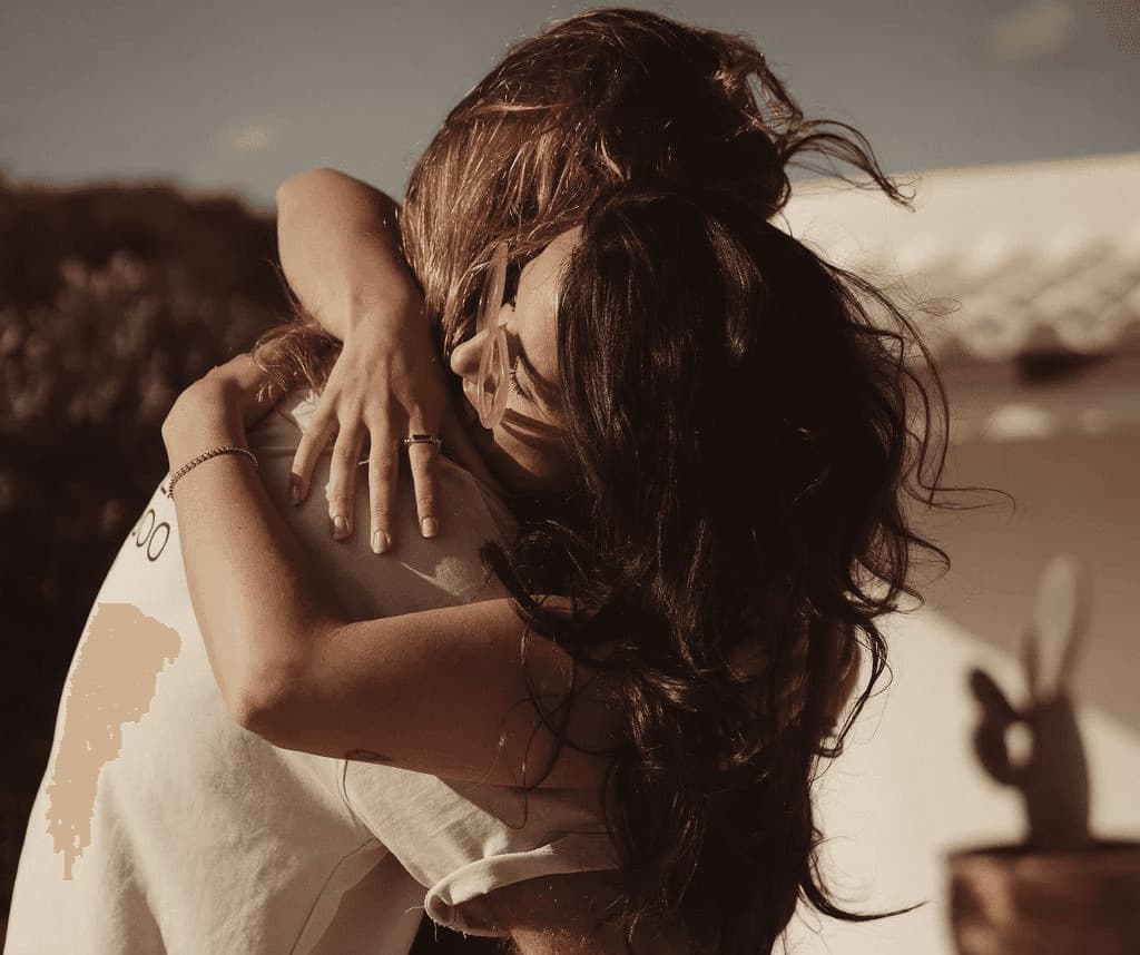 Couple in a tight, sunlit embrace